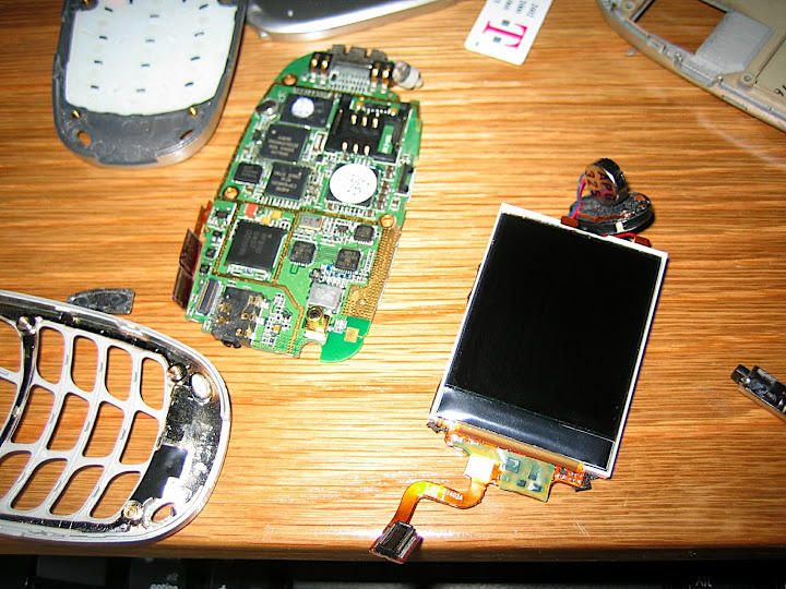 The front of the main PCB and the main screen on the right. Interesting things on the main PCB are the SIM card connector and the grounding between the RF circuits toward the top of the main PCB and the rest of the board.